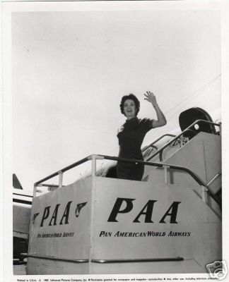 1957 A customer waves goodbye as she boards a Pan Am Clipper.